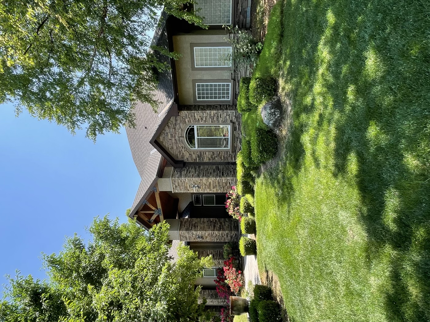 Luxury stone home with professional landscape installation